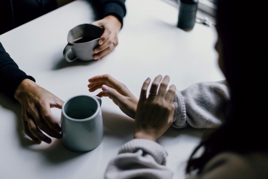 Ein Paar das beim Kaffeetrinken Deep Talk führt.